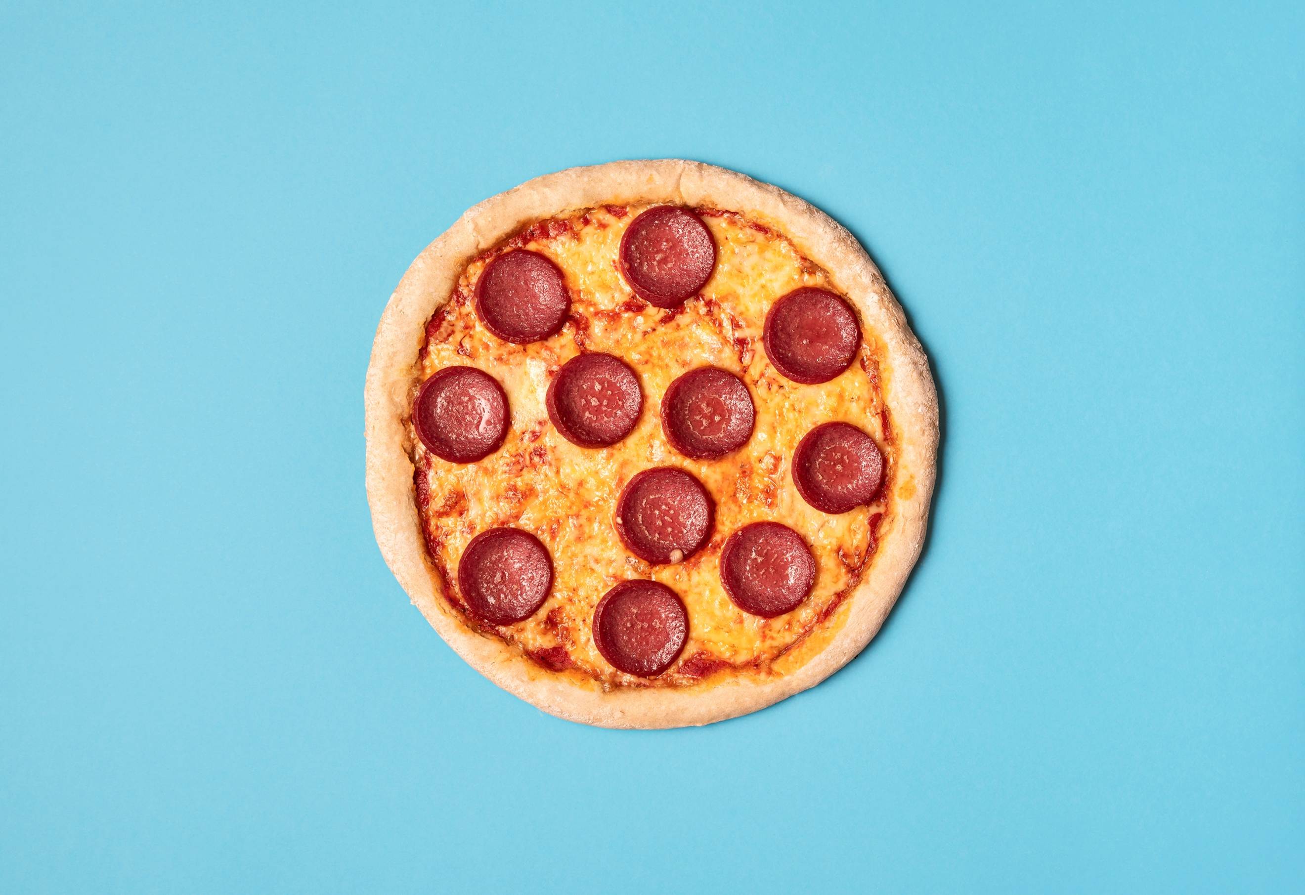 Pepperoni pizza on blue background